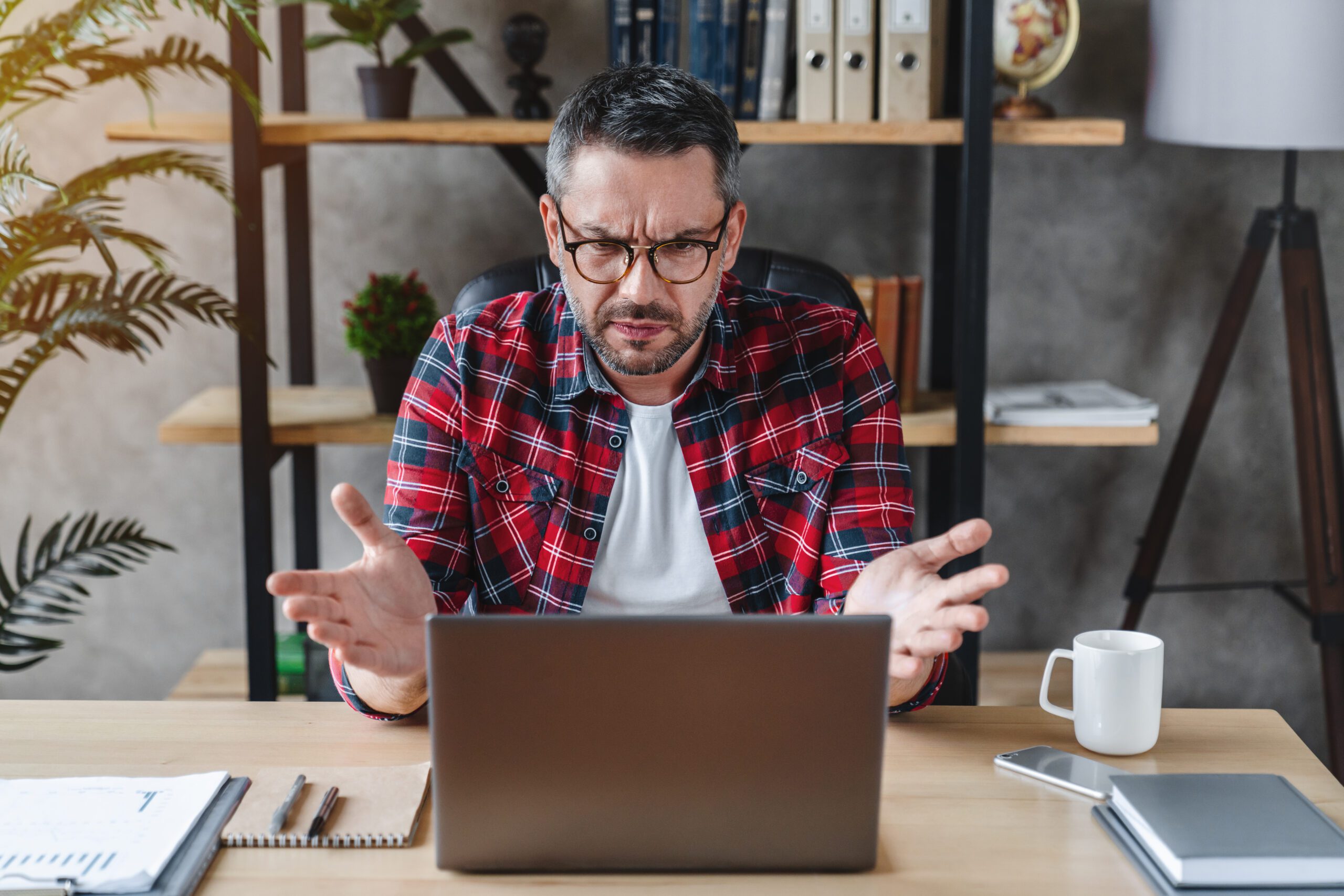 Frustrated man wondering how to fix the orientation on his computer.How to Rotate the Screen Windows 10