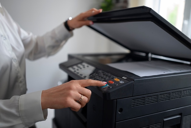 Free photo woman at work in the office using printer